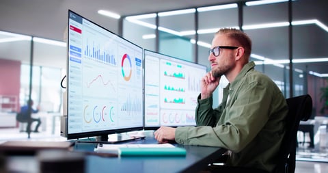 Analyst reviewing threat data and intelligence dashboards