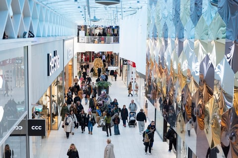 Shopping center interior with retail stores and shoppers