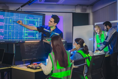 Security team coordinating monitoring operations in control room