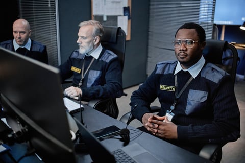 Security team monitoring surveillance in control room