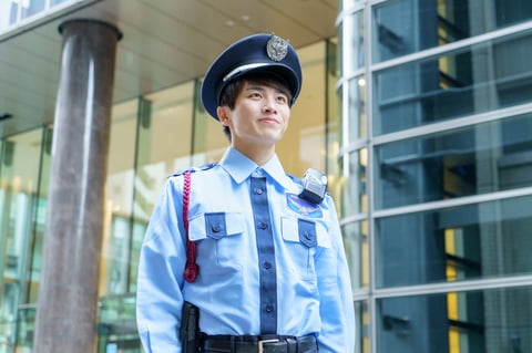 Professional security guard standing vigilantly at a building