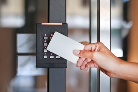 Person using access control keycard at door